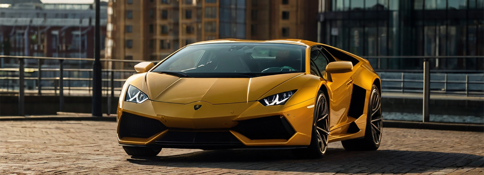 A yellow Lamborghini Sports Car parked on a brick road